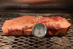 A piece of meat on a grill with a SpitJack Dual Sensor Meat and Oven Thermometer (2 Pack) on it.