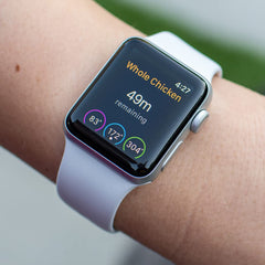 A close-up of the MEATER Plus smartwatch on a wrist displays a cooking timer for 