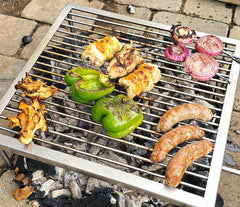 Assorted meats and vegetables grilling on a SpitJack Tuscan Campfire Gridiron. All Stainless - 300 Sq. In. Grate grill.