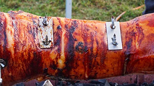 A large piece of meat being cooked on a SpitJack Stainless Rotisserie Trussing U-Bolt - 8" (2 Pack) grill.