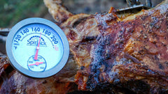 A SpitJack Dual Sensor Meat and Oven Thermometer (2 Pack) is attached to a piece of meat.