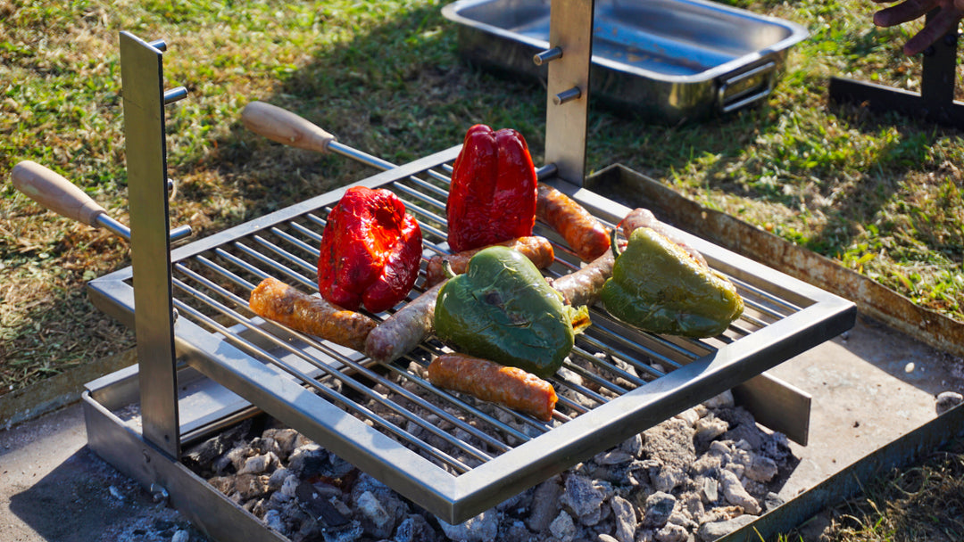A SpitJack ALL Stainless Tuscan Fireplace and Camping Grill Bundle - DX with some meat on it.
