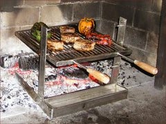 A SpitJack ALL Stainless Tuscan Fireplace and Camping Grill with meat on it.