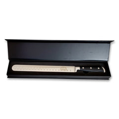 A Deluxe Brisket Slicing Knife - 11 Inch Blade, Competition-Chef Series in a black box with a black handle, branded by SpitJack.